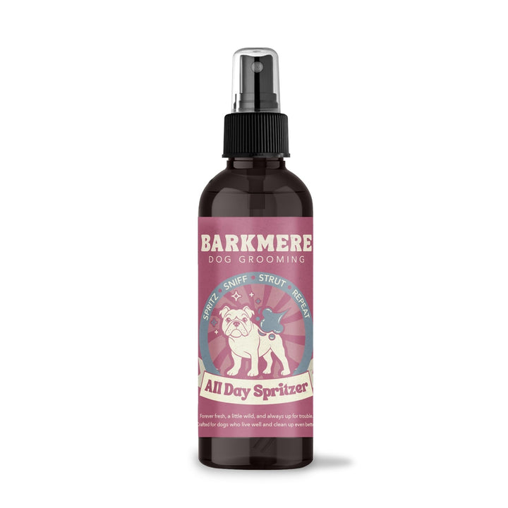 Barkmere All Day Spritzer in an amber spray bottle with a pink bulldog label and black misting pump