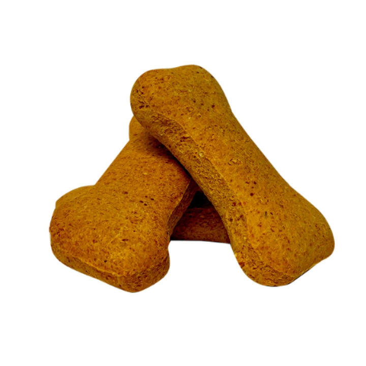 Two peanut butter bone biscuits with a coarse golden-brown crumb, stacked on a white background