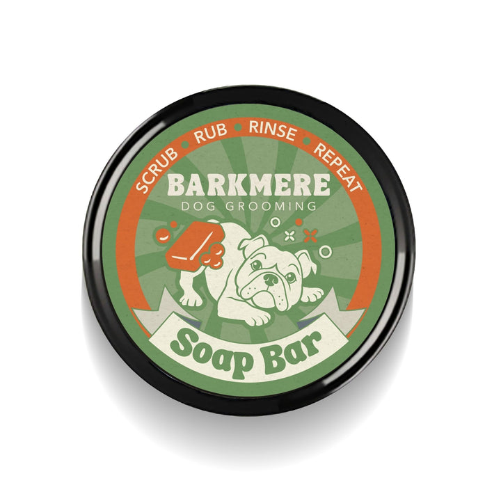 Top of the Barkmere Soap Bar tin, a green and orange lid with a bulldog and scrubbing bubbles