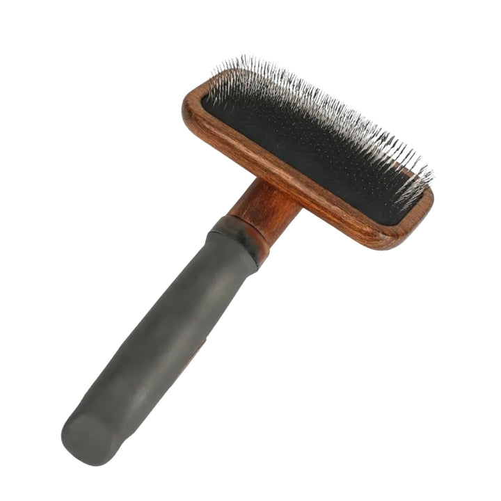 Slicker brush with a curved timber head, fine bent wire pins and a soft grey rubber handle